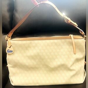 Dooney & Bourke shoulder bag. Cream color with tan leather trim.